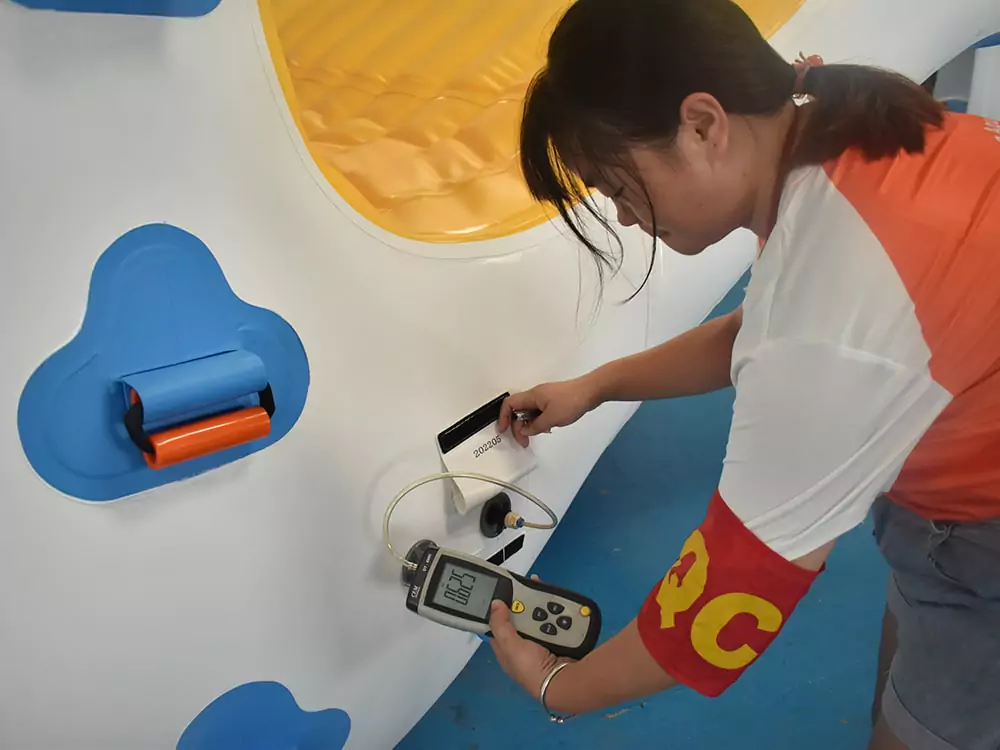 the-staff-measuring-air-pressure-of-an-aquatic-inflatable