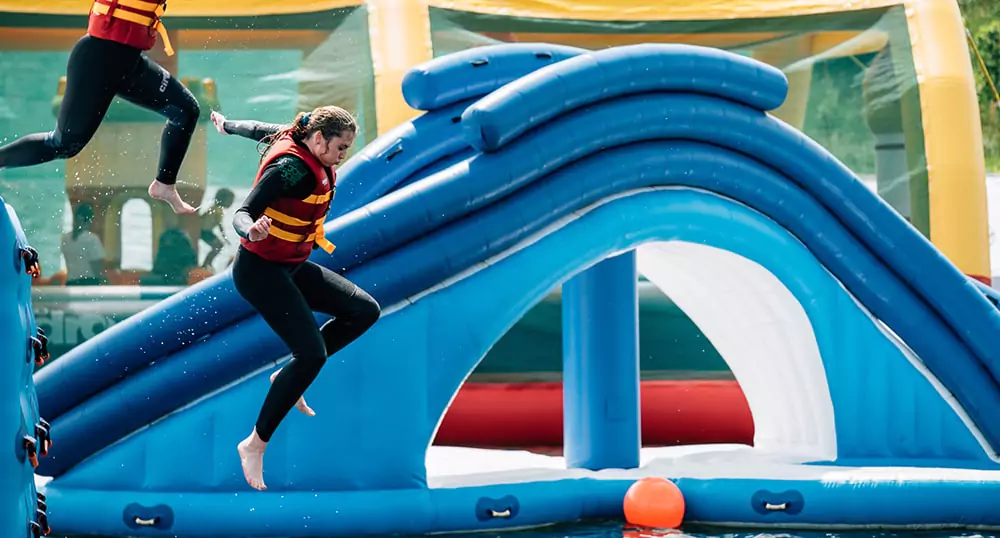 two-players-jumping-from-floating-water-inflatables