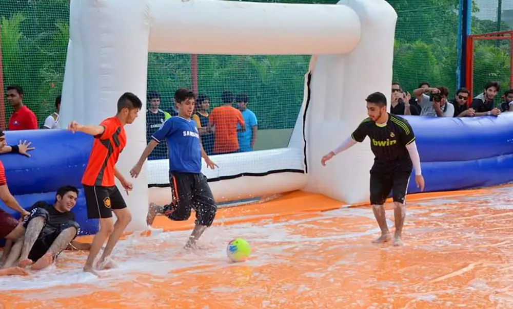 players-enjoying-a-slippery-inflatable-soccer-pitch