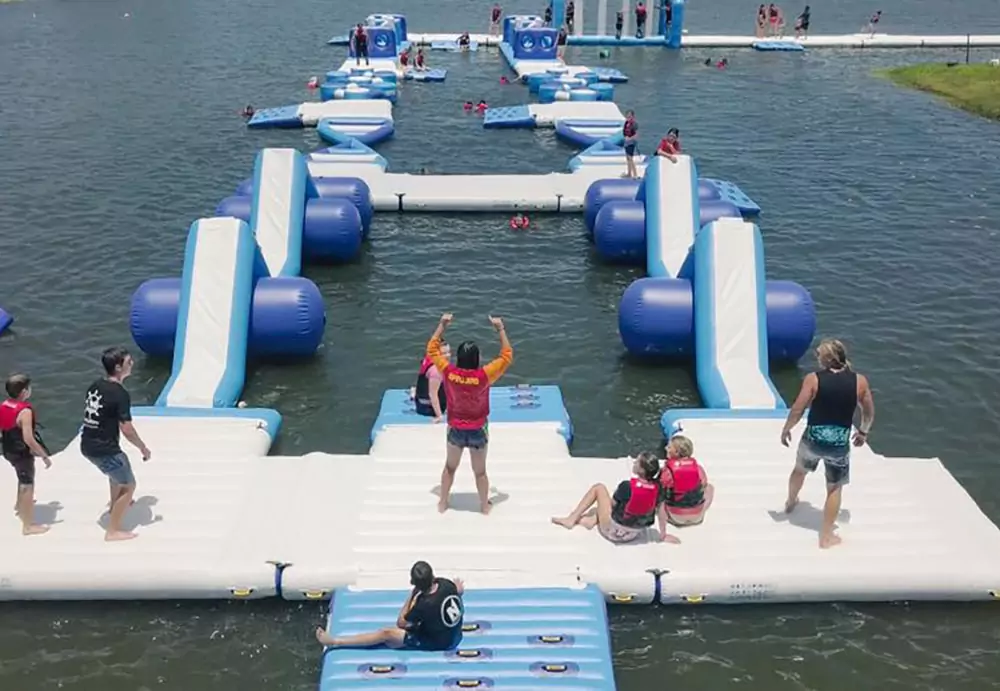 a-long-floating-water-park-is-installed-on-a-lake