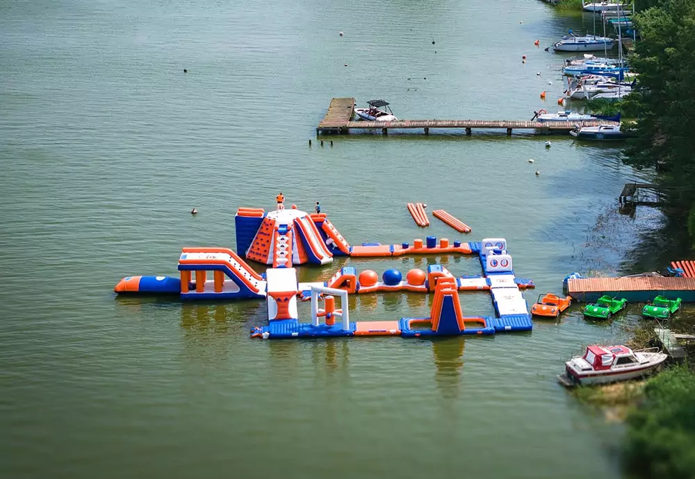 a-floating-water-park-is-installed-on-a-natural-lake