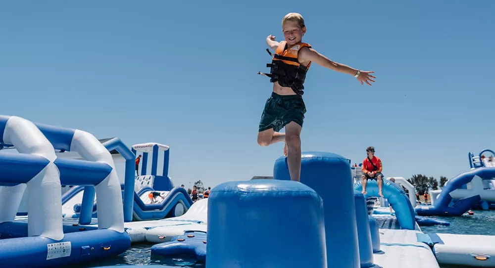 kid-playing-at-an-inflatable-water-park