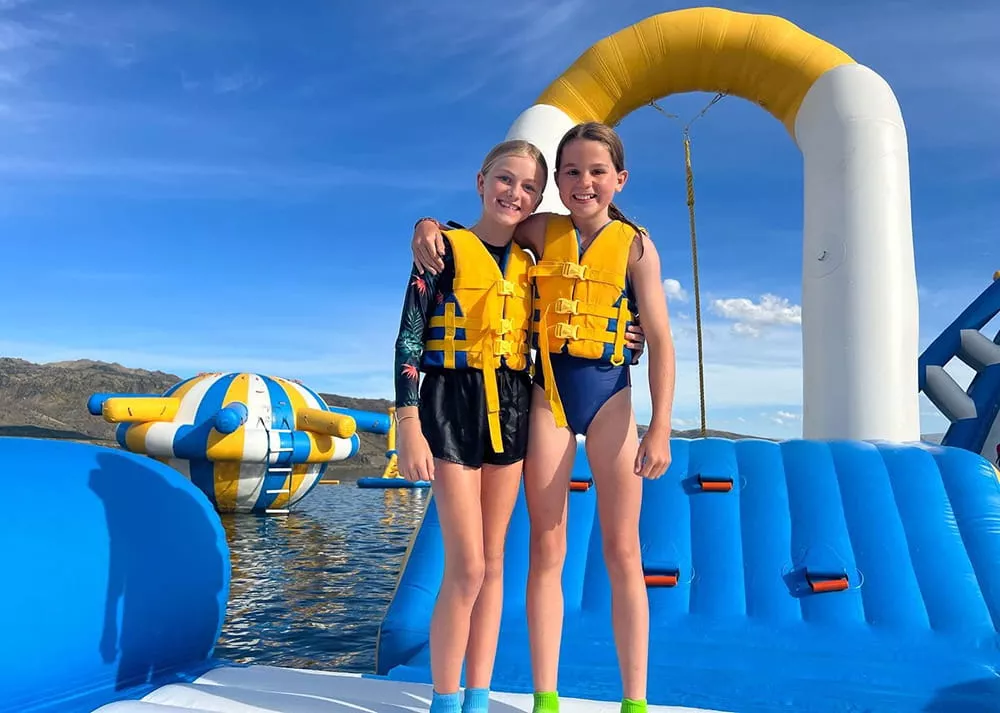 child-correctly-wearing-life-jacket-at-inflatable-water-park