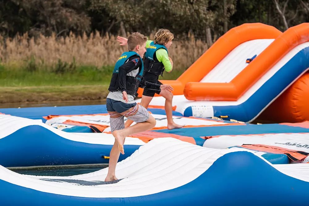 children-playing-on-low-difficulty-floating-inflatable-obstacle-course