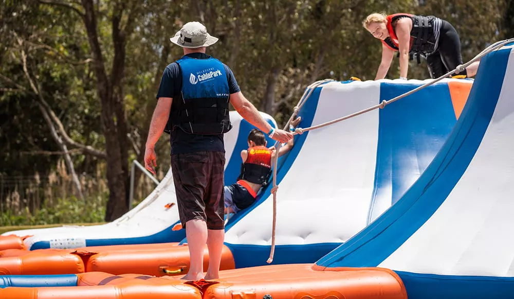 staff-supervising-difficult-floating-inflatable-obstacle-course-module