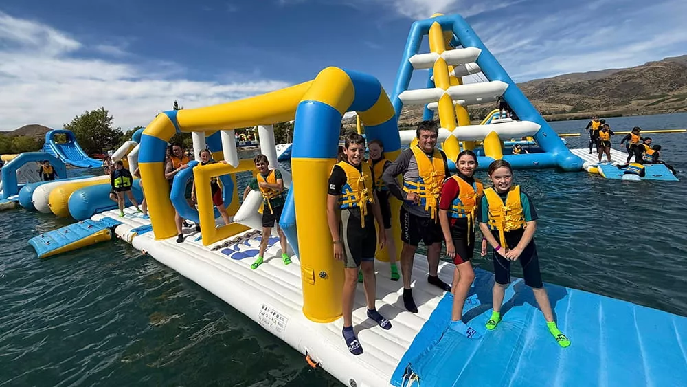 teenagers-enjoying-an-inflatable-water-park-for-lake