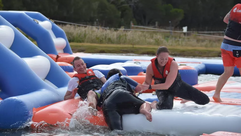 friends-enjoying-an-inflatable-aqua-park-together