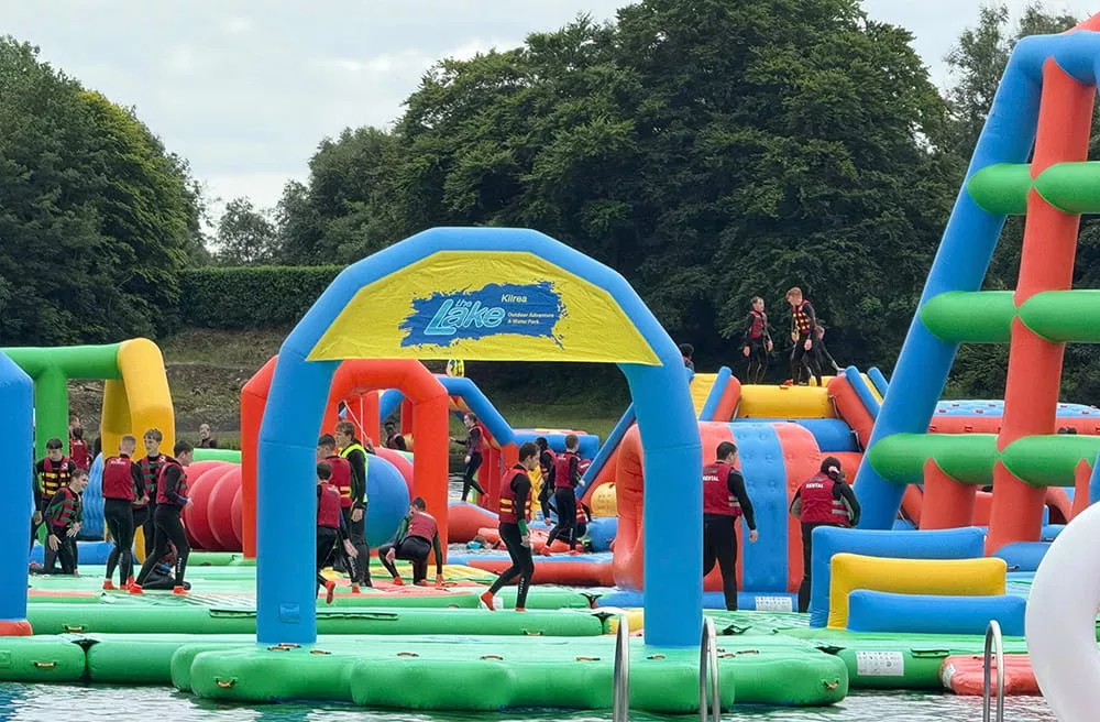 Busy inflatable water park in UK with many visitors