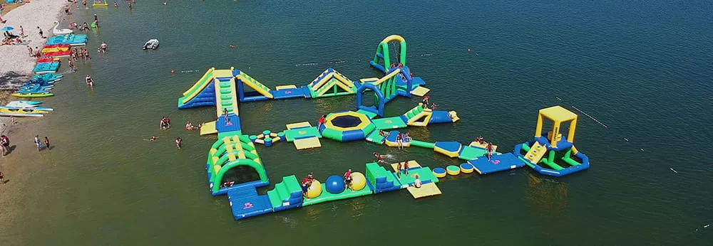 Commercial inflatable water park operating on a lake